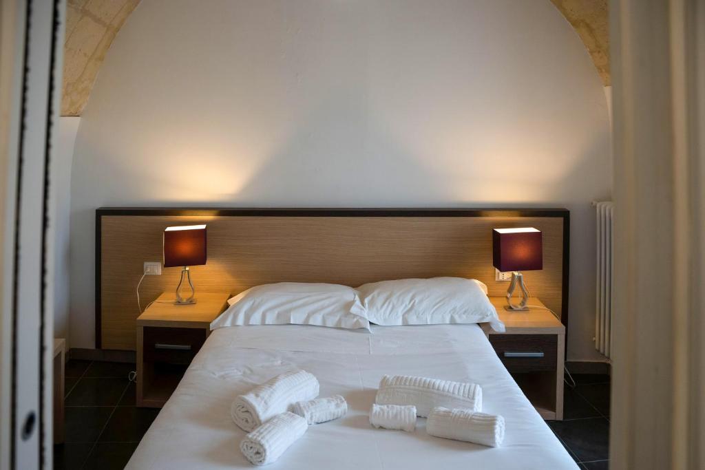 Postel nebo postele na pokoji v ubytování Residence Le Vie Del Mosto