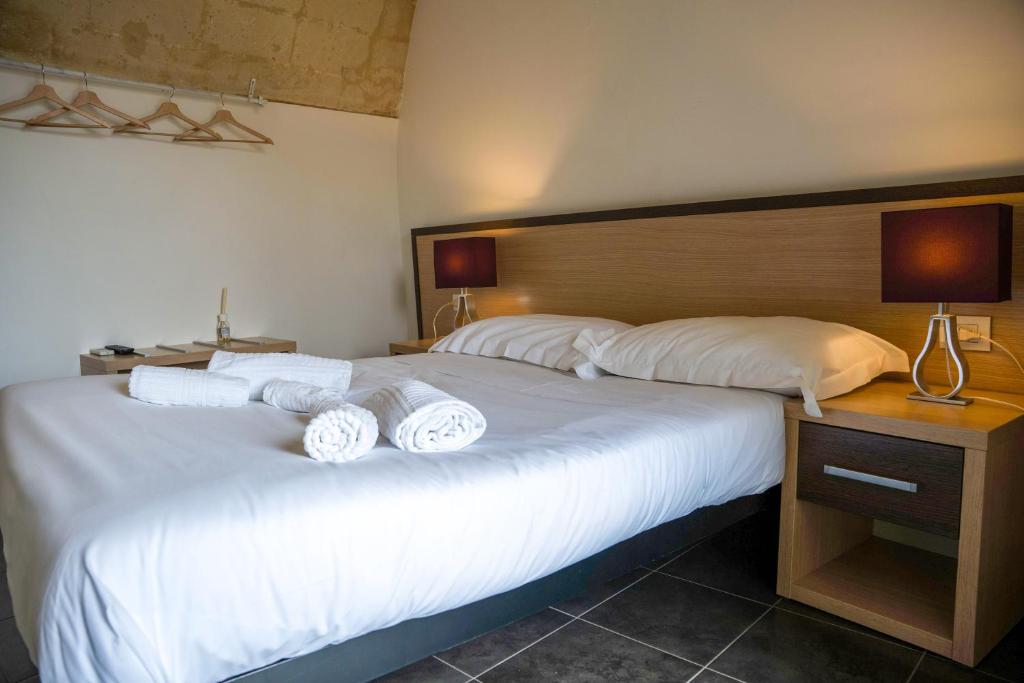 Postel nebo postele na pokoji v ubytování Residence Le Vie Del Mosto