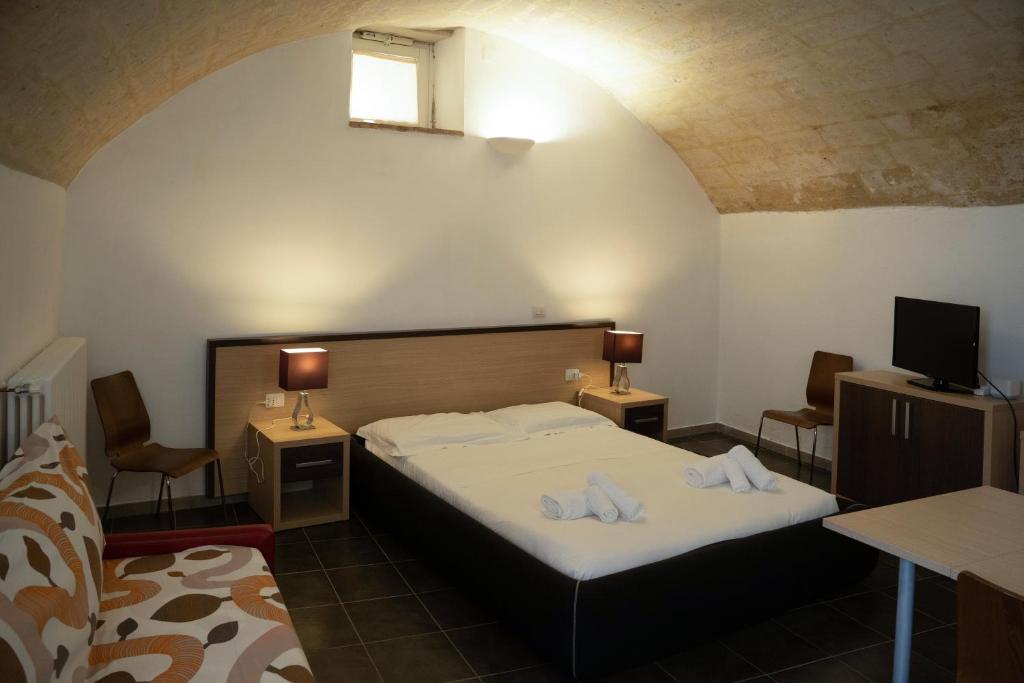 Postel nebo postele na pokoji v ubytování Residence Le Vie Del Mosto