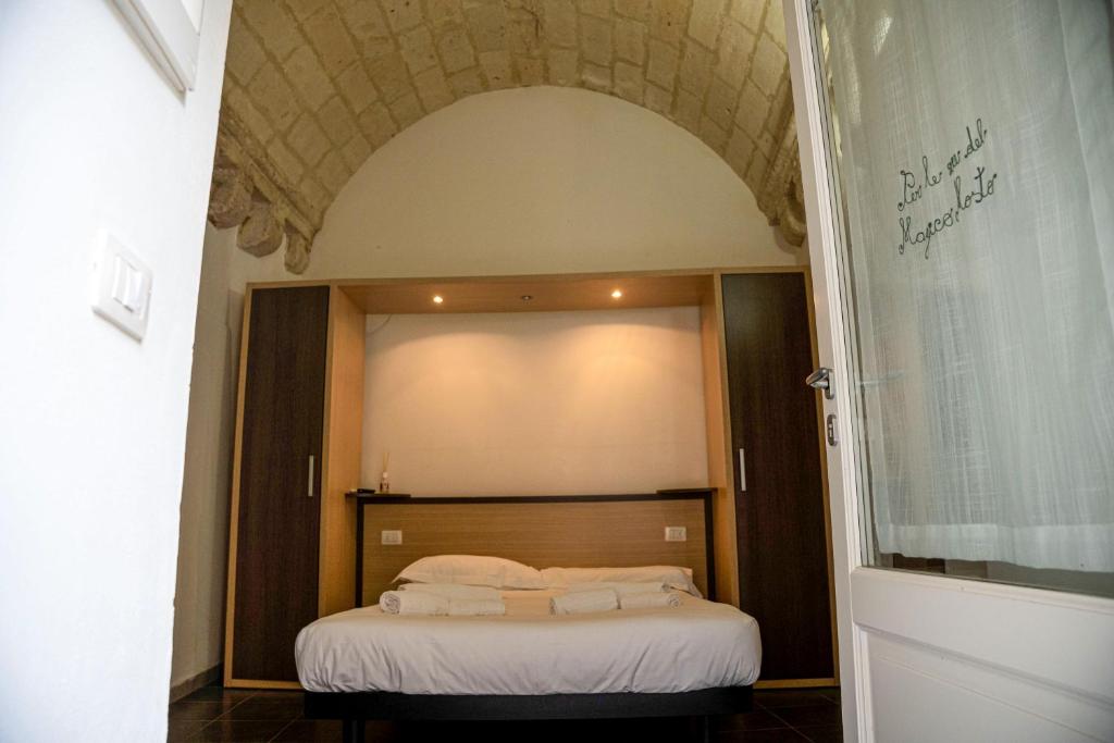 Postel nebo postele na pokoji v ubytování Residence Le Vie Del Mosto