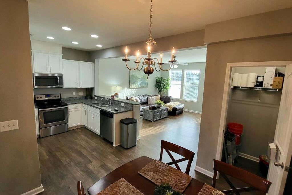 uma cozinha e sala de estar com uma mesa e um sofá em Mackintosh Townhome em Burlington