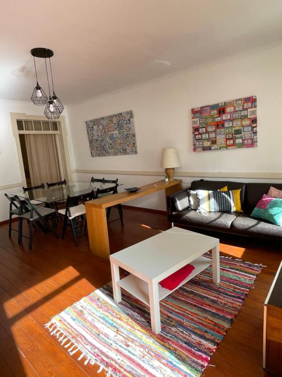 uma sala de estar com um sofá e uma mesa em Apartamento central para grupo ou familias em Lisboa