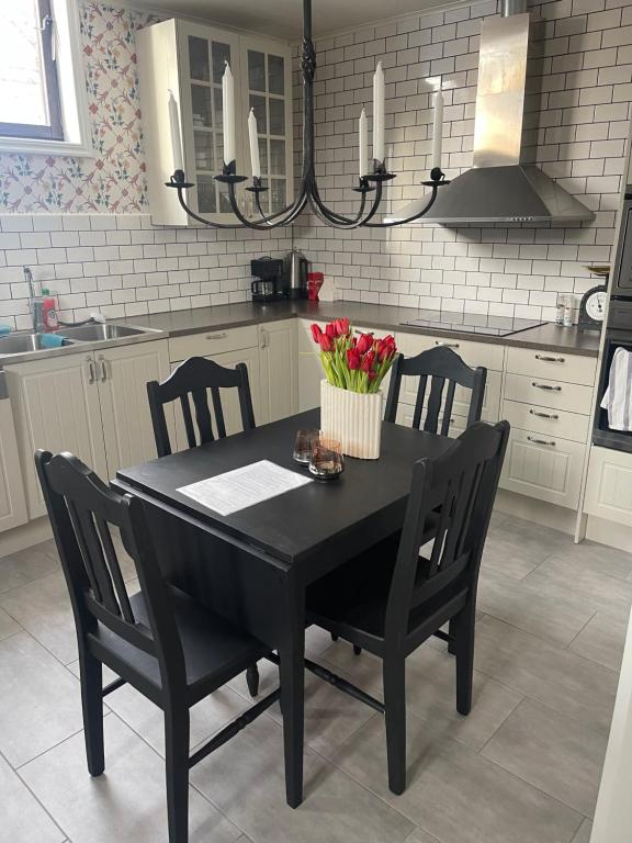 a kitchen with a black table with chairs and a black dining room at Utterbyn/Sirsjön 