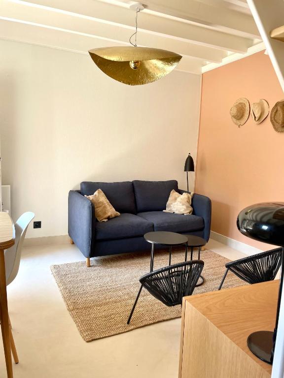 a living room with a blue couch and a table at Appartement duplex in Le Touquet-Paris-Plage
