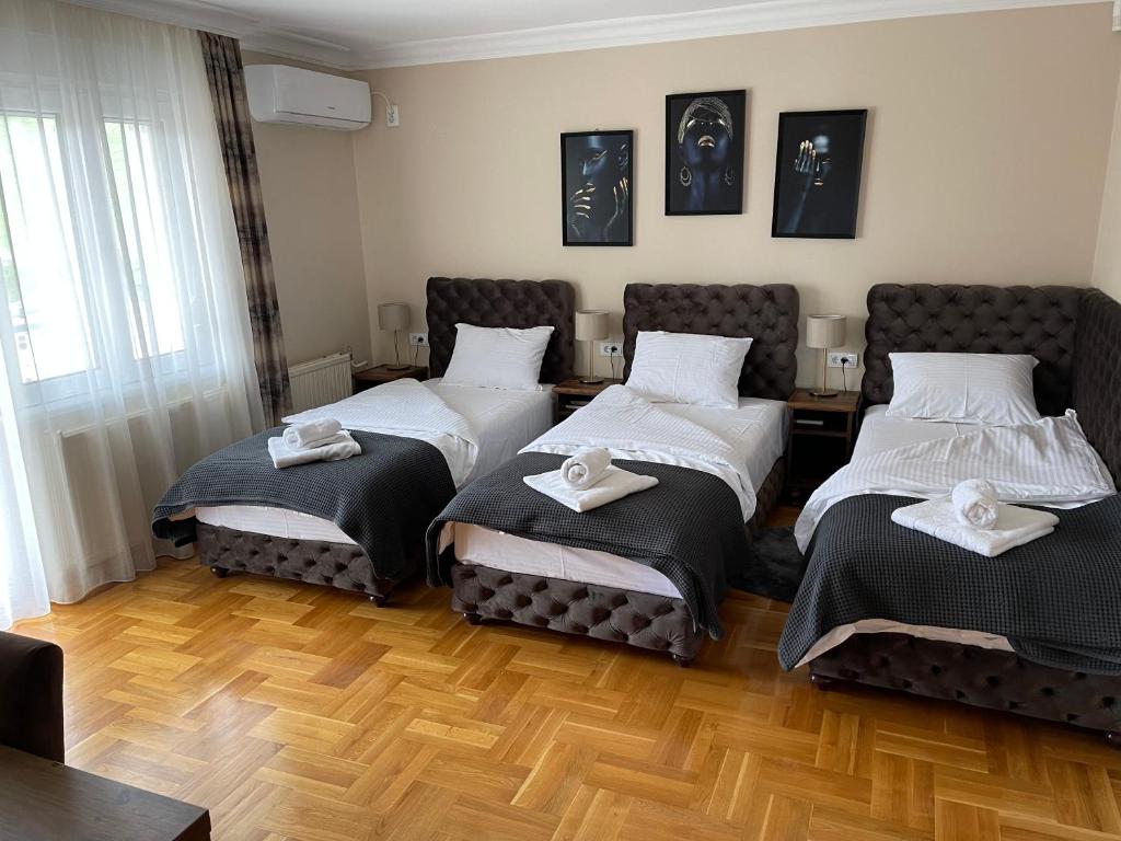 a room with two beds with towels on them at Vila Jovanovic in Barajevo