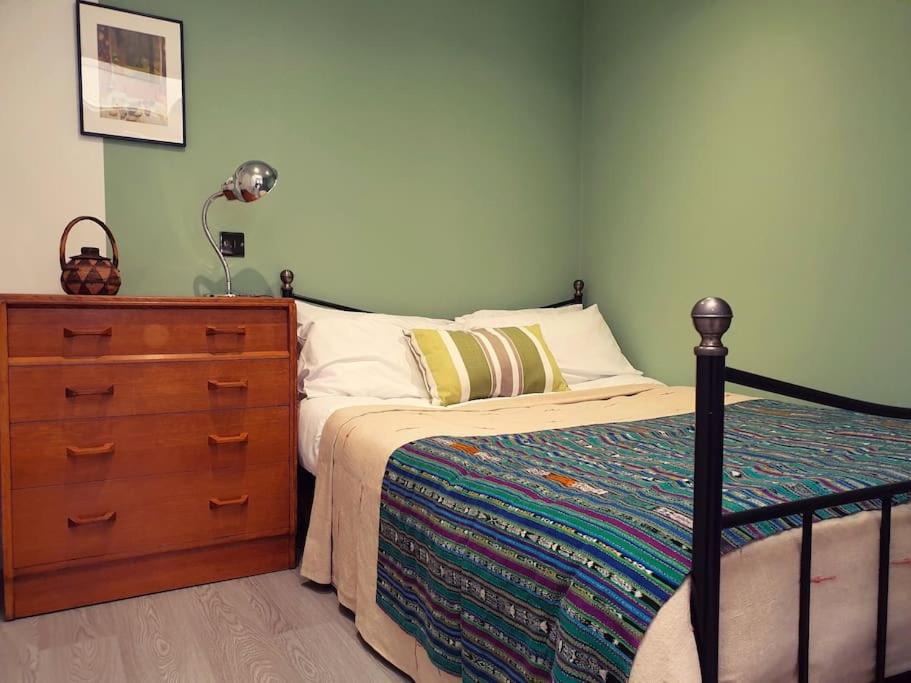 a bedroom with a bed and a dresser at No. 3 Bligh's Yard in Canterbury