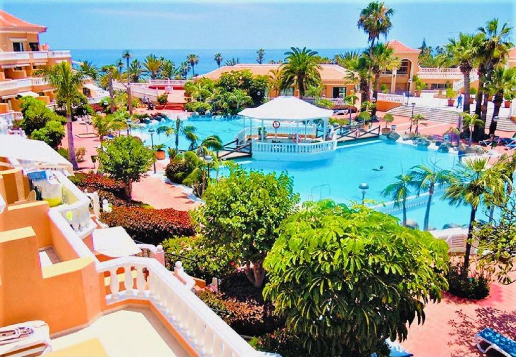an aerial view of a swimming pool at a resort at Boho Chic on the Beach by Deihu Experiences in Playa de las Americas
