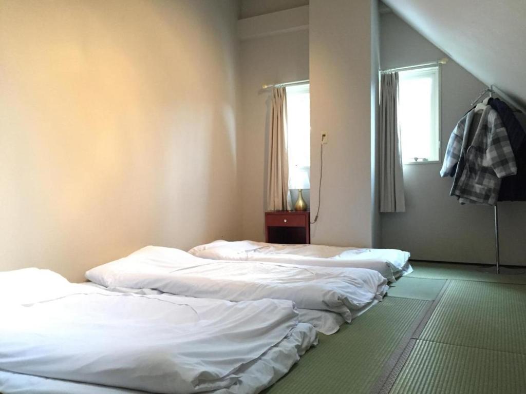 A bed or beds in a room at Hakuba Sun Valley Hotel Annex - Vacation STAY 90344v