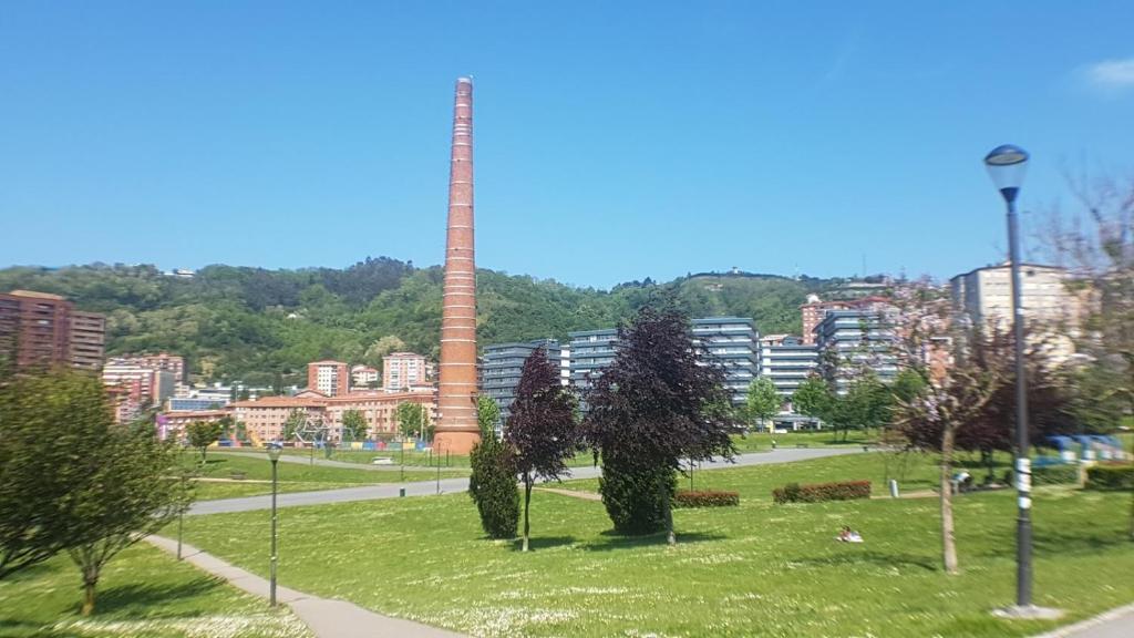 a tall tower in the middle of a park at Etxeberria Park by Next Stop Bilbao in Bilbao