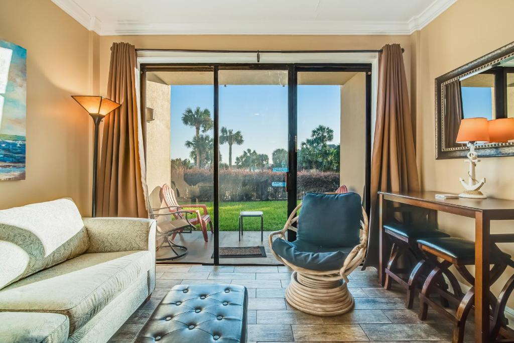 a living room with a couch and a desk at Pirates Bay A113 in Fort Walton Beach