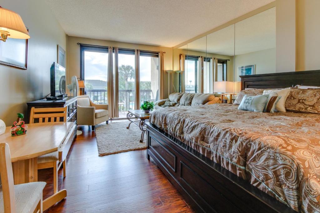 a bedroom with a large bed with a desk and a desk at Pirates Bay A204 in Fort Walton Beach