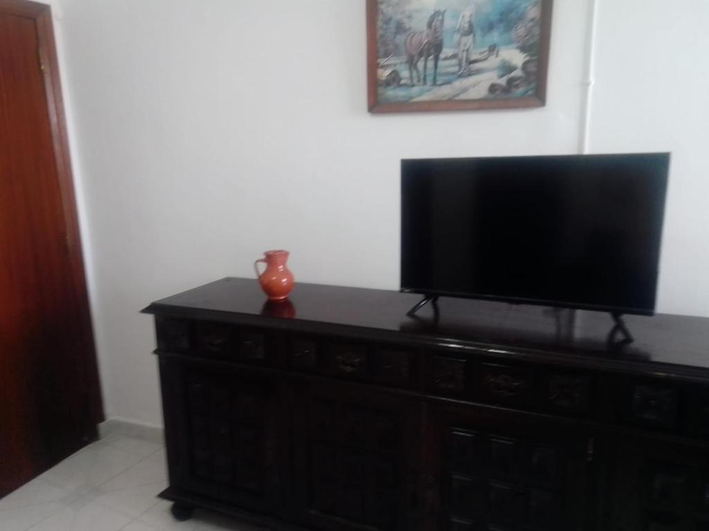 a flat screen tv sitting on top of a dresser at Casa Aires Varela in Elvas
