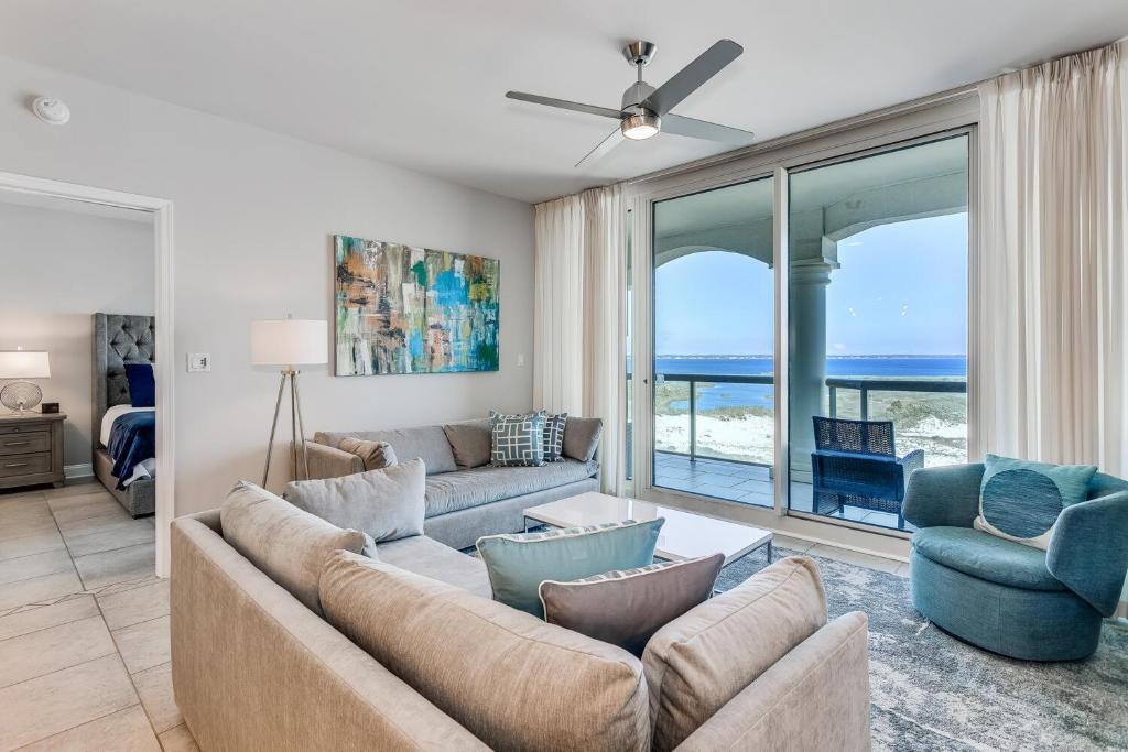 a living room with a couch and two chairs at Portofino Island Resort Tower 2-703 in Pensacola Beach