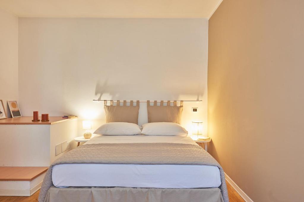 a bedroom with a large bed with two pillows at Residenza Jasmine - La Guarida in Udine