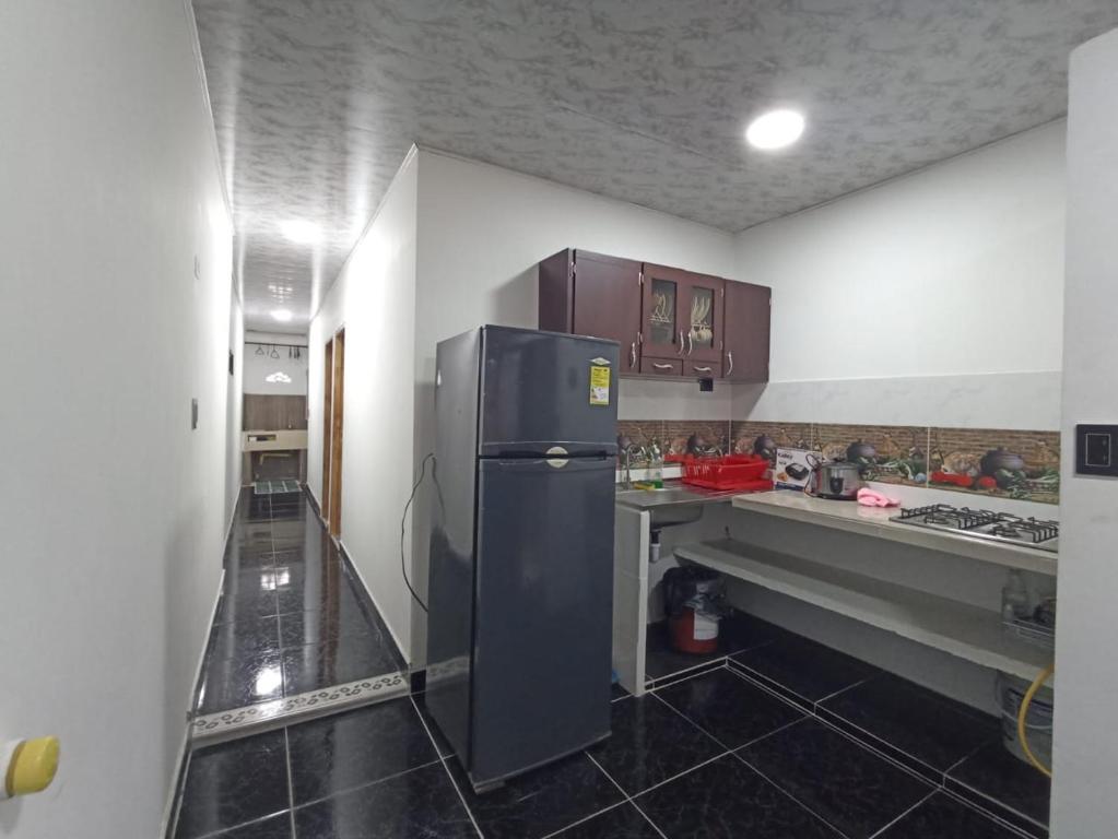 a kitchen with a black refrigerator in a room at Apartamento, La paz in Puerto Triunfo
