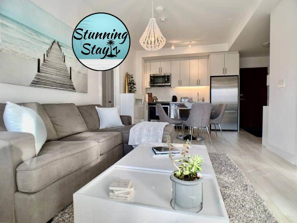 a living room with a couch and a table at Stunning Stayz At Friday Harbour Beach Marina Resort Lake Simcoe Innisfil in Innisfil