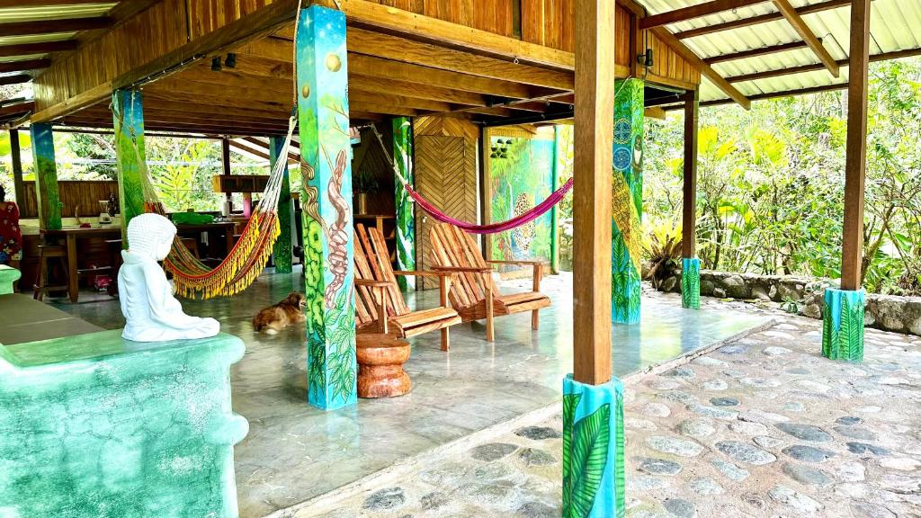 a porch of a house with a hammock at Casa Aire Libre in Puerto Jiménez