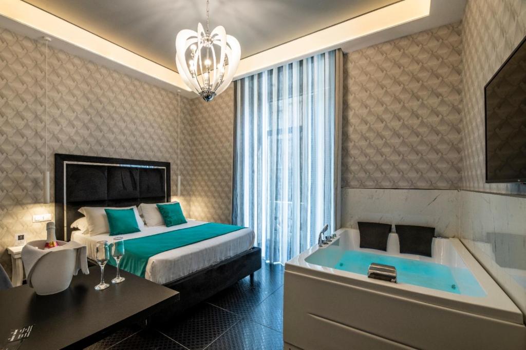 a bedroom with a bed and a bath tub at Luna Luxury Bed and Breakfast in Naples