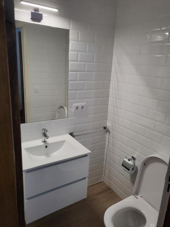 a white bathroom with a sink and a toilet at D&L piso compartido in Vigo