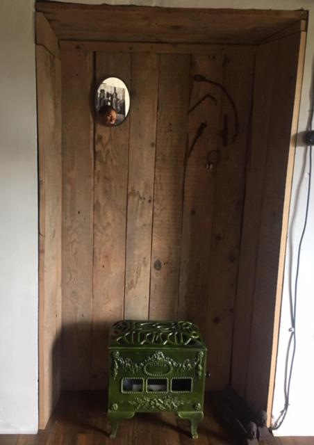 a wooden door with a green suitcase in a room at Earth, Mountains and Snow in Saint-Laurent-de-Neste