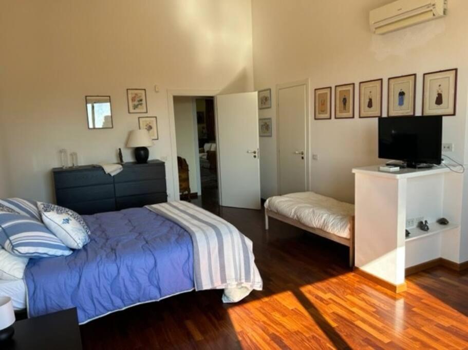 a bedroom with a bed and a flat screen tv at Villa del Sole in Valverde