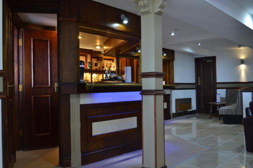 a bar with a pillar in a room at Jini Hotel in Blackpool