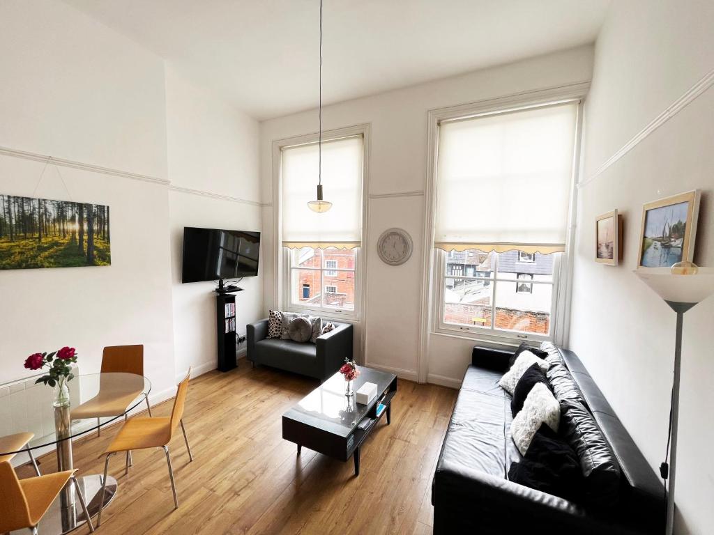 a living room with a couch and a table at On the Quay in Harwich