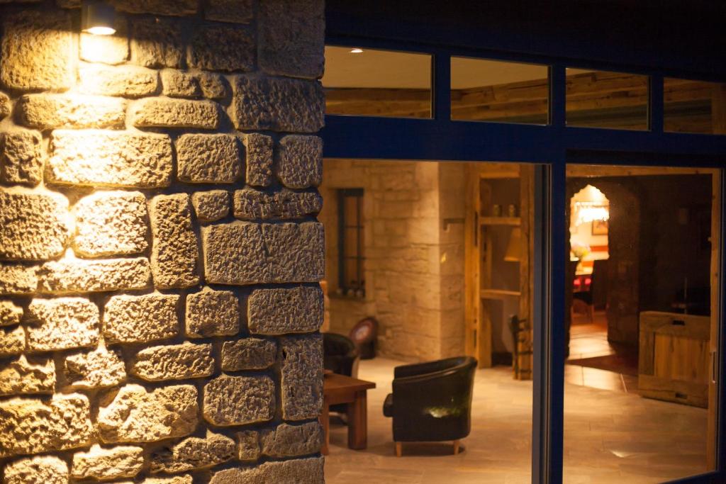 a room with a stone wall and a window at Gästehaus Craintaler Mühle B&B in Creglingen