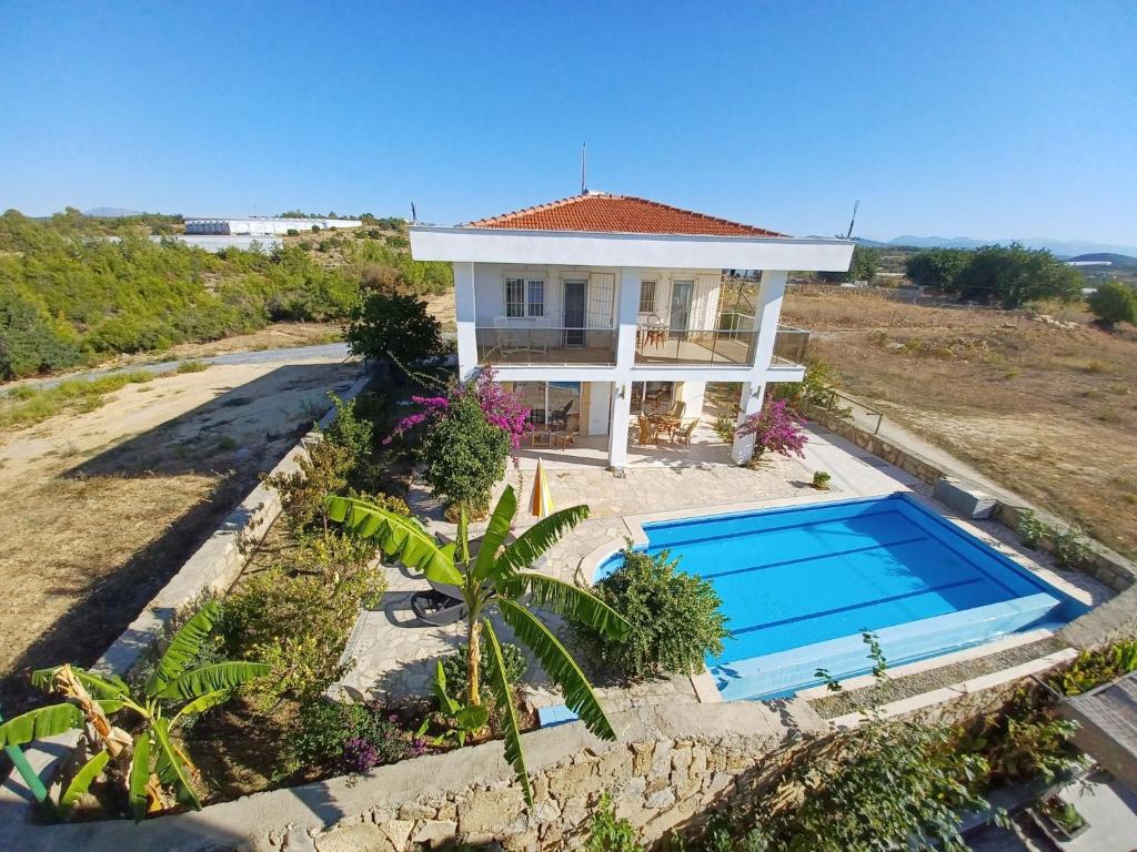 an aerial view of a house with a swimming pool at Villa Delia in Okurcalar