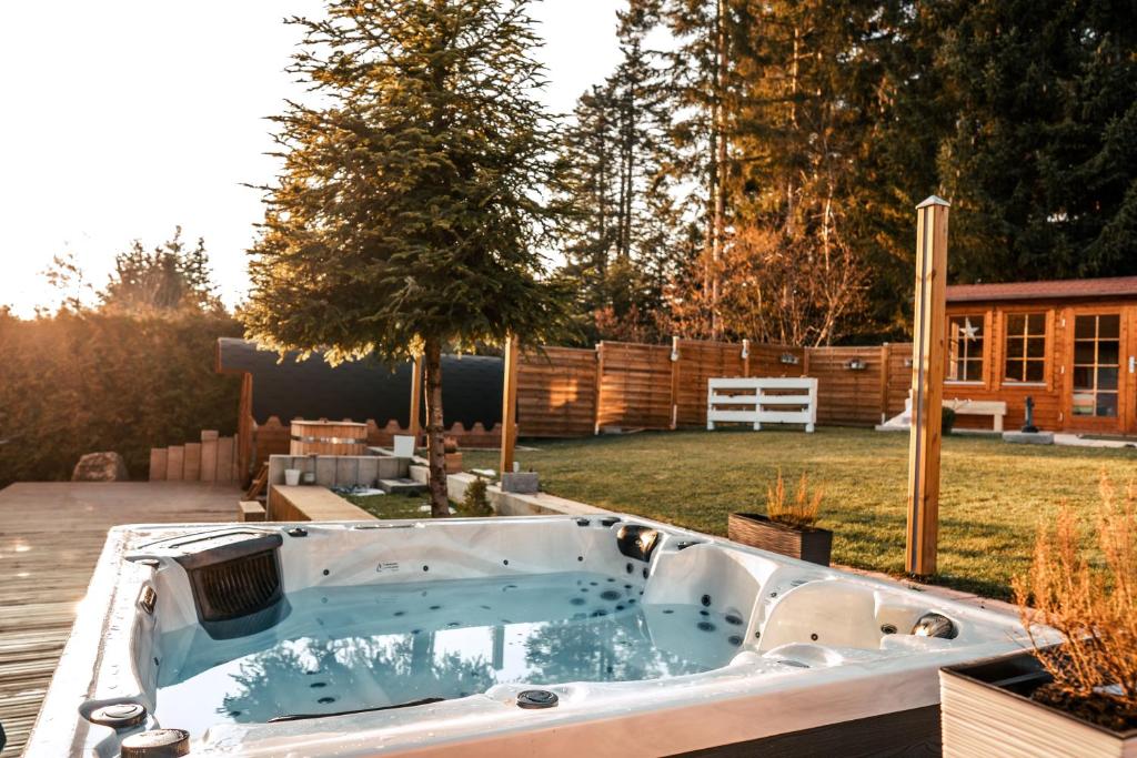 a jacuzzi tub in the backyard of a house at Wellnessoase Nordschwarzwald in Neuweiler