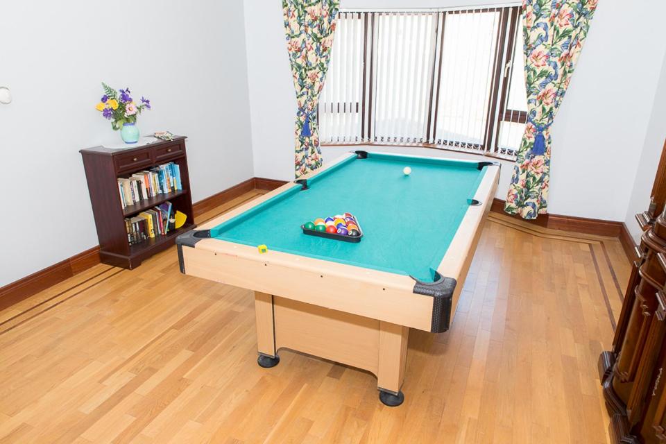 a pool table in the middle of a room at Bree House Malin Head in Malin Head