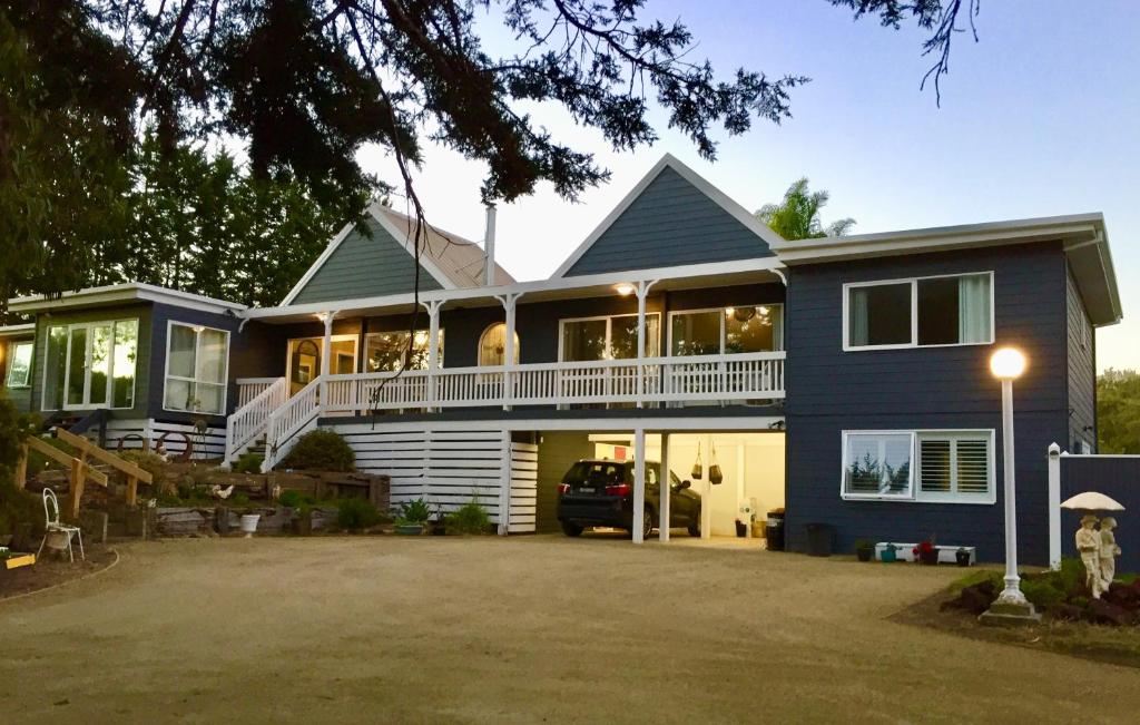 a large blue house with a large driveway at Hamptons In Rye Studio - 3 Mins from Famous Hot Springs! in Rye