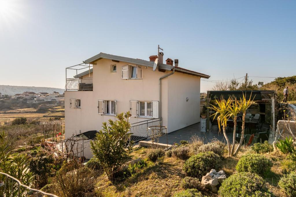 a house in the middle of a field at Apartments with parking space Lopar, Rab - 14070 in Lopar