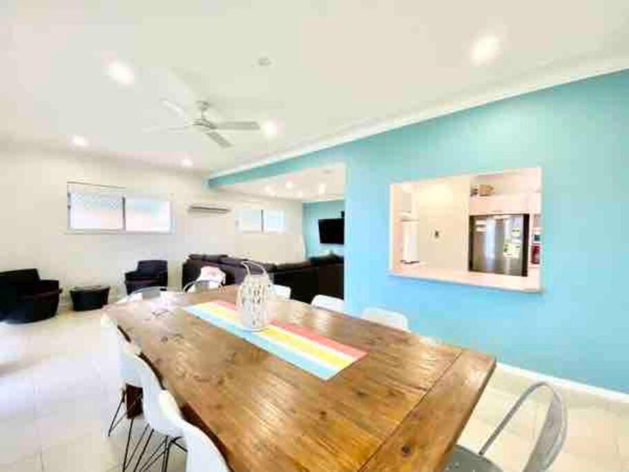 a dining room with a wooden table and chairs at Nelson Bay home on the beach!! in Nelson Bay