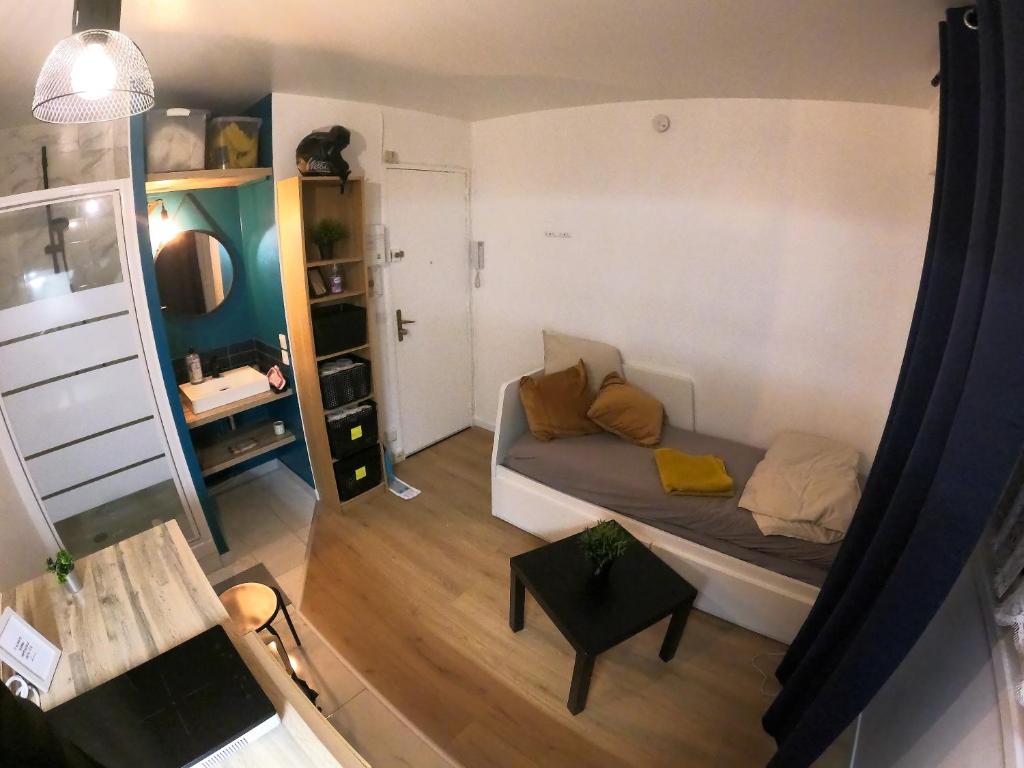um pequeno quarto com uma cama e uma mesa em Au Bord Du Lac - Arrivée 24H/24H em Meudon