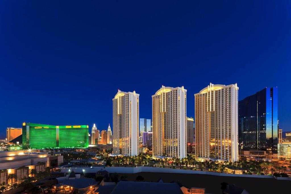 a city skyline at night with tall buildings at MGM SIGNATURE - Balcony Suite Strip View - FREE valet parking in Las Vegas