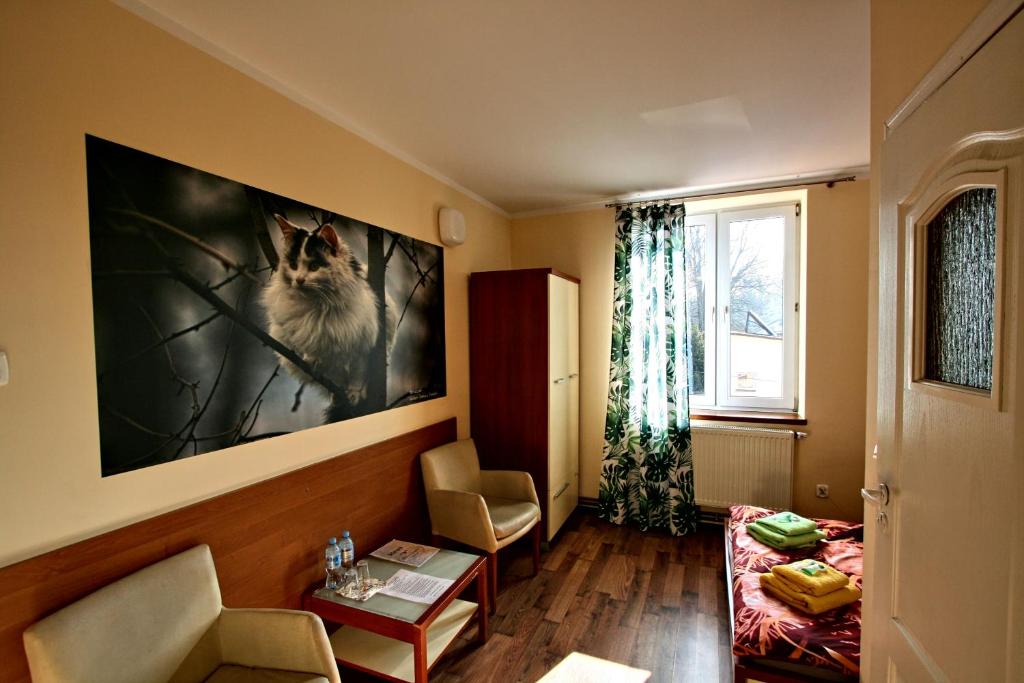- un salon orné d'une peinture de chien sur le mur dans l'établissement "Aleksandrówka" Restauracja i Noclegi, à Horyniec
