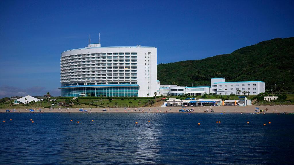 a large building on the beach with a beach and the ocean at Irago Resort & Convention Hotel in Tahara