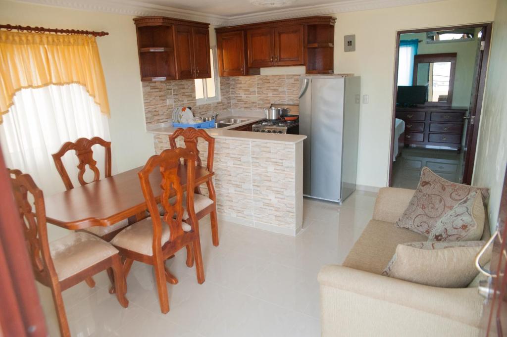 a kitchen and dining room with a table and chairs at Tropical Island Apartahotel- one bedroom looking to the city in La Viva