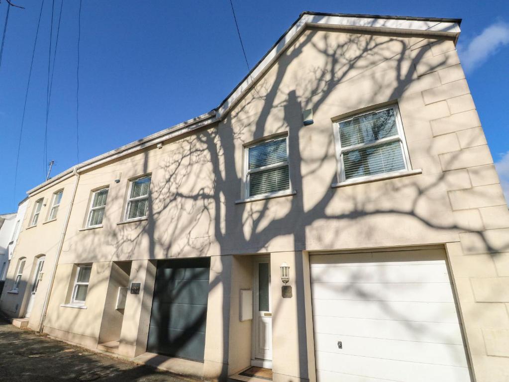 a white building with a white garage door at 1 Kents Mews in Torquay