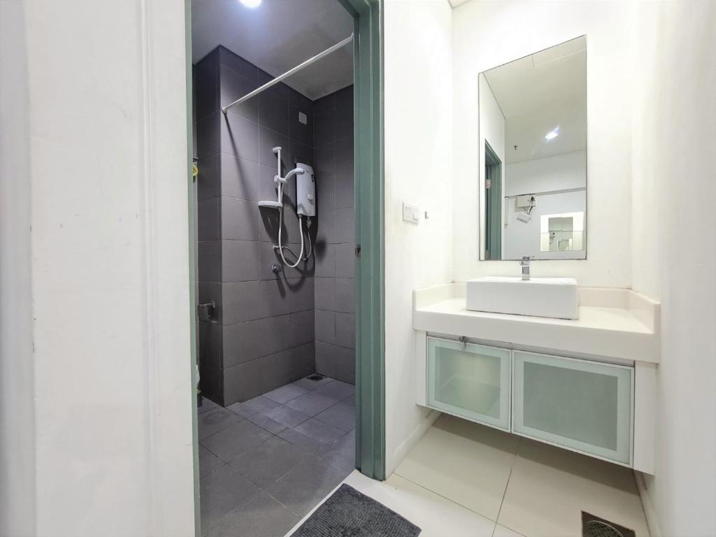 a bathroom with a sink and a mirror at Summer Suite KLCC By Citybox in Kuala Lumpur