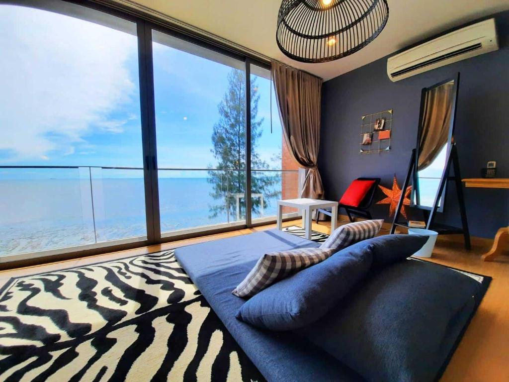 a bedroom with a zebra print bed with a large window at Sandbox frontbeach villa4 in Bang Lamung