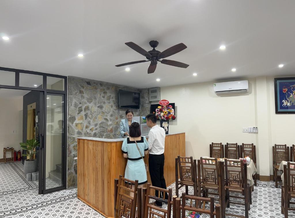 a group of people standing at a bar in a room at Tam Coc Paradise Homestay in Ninh Binh