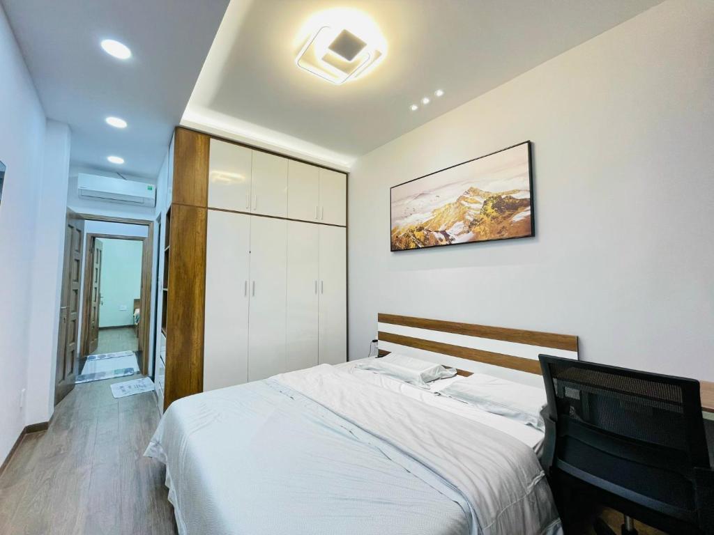 ホーチミン・シティにあるThái Vân Homeのベッドルーム1室(ベッド1台付)が備わります。壁に絵が飾られています。
