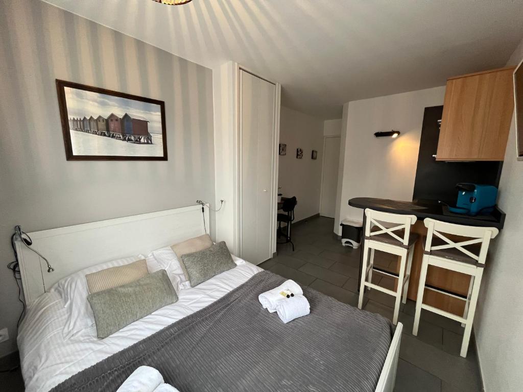 Dormitorio pequeño con cama y mesa en Meres YourHostHelper, en Caen