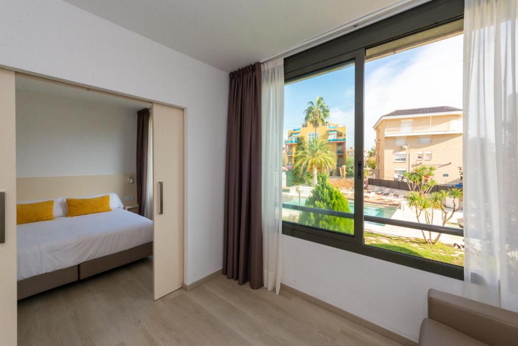 Postel nebo postele na pokoji v ubytování Atenea Park Suites & Apartments