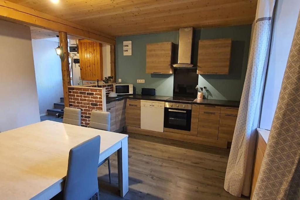 a kitchen with a table and a dining room at Appartement 6/8 personnes 