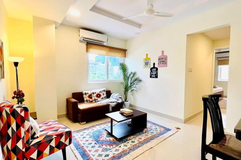 a living room with a couch and a table at BluO 1BHK Gachibowli - Terrace Garden, Lift in Hyderabad