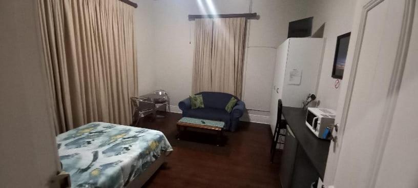 Zimmer mit einem Schlafzimmer mit einem Bett und einem Schreibtisch in der Unterkunft Glen Lilly Self Catering in Parow