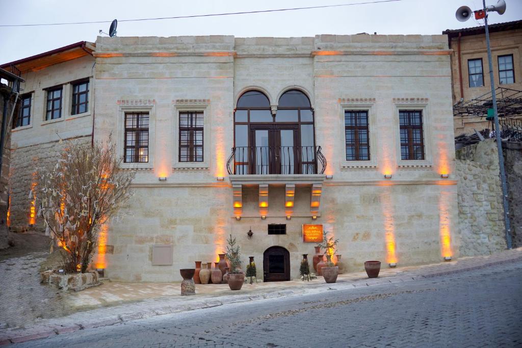 a large stone building with orange lights on it at Yeşil Konak Cave Hotel in Ürgüp